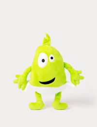 Green plush toy with a tuft on top, large uneven eyes, a wide smile, and a white waistband.