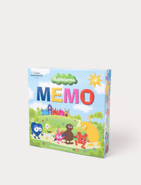 A box of the Babblarna Memo game with colorful characters on a grassy landscape under a blue sky.