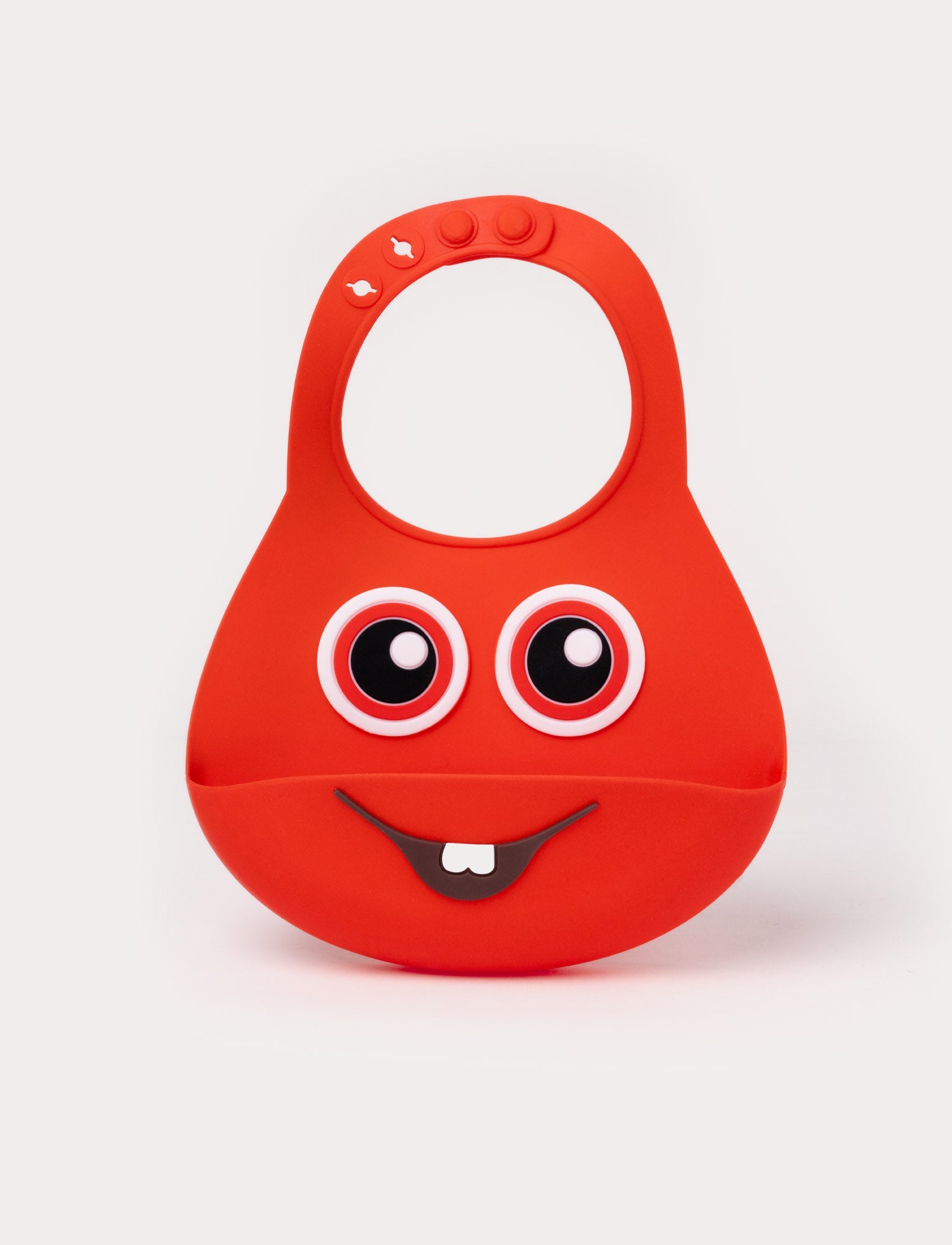 Image of Red silicone bib with an adjustable neck, a spill pocket, and a playful face design with big eyes and a toothy smile.