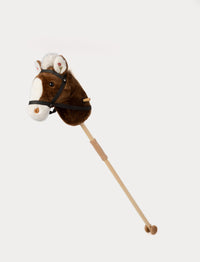 Classic brown plush hobby horse with a wooden stick, black bridle, and soft white mane.