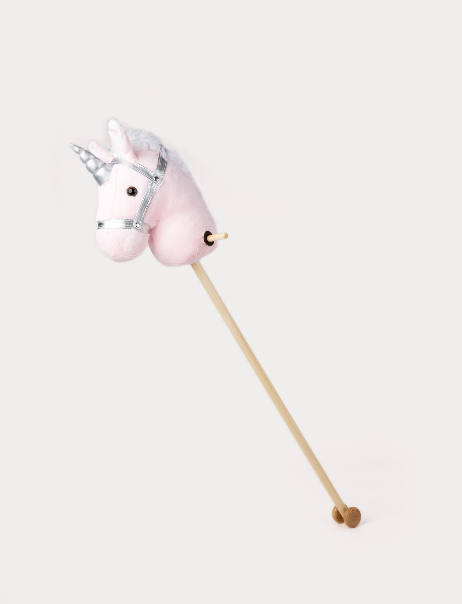  Image of Plush hobby unicorn with a soft pink head, silver horn, matching bridle, and a wooden stick with wheels.