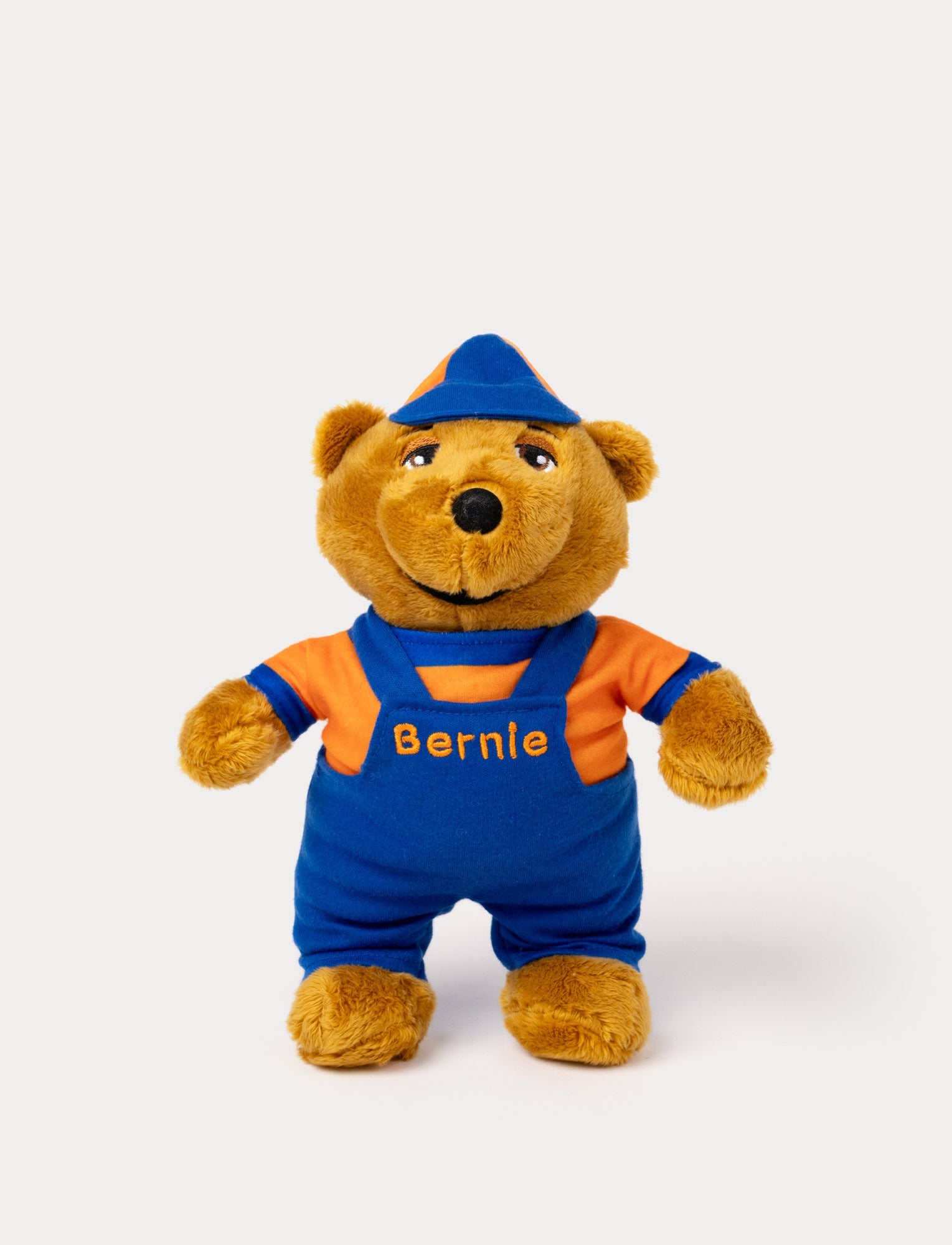  Image of A plush toy of Bernie the bear wearing blue overalls and an orange shirt with his name embroidered.