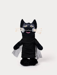 A plush toy of a black cat wearing a dark outfit with mesh cape detail.