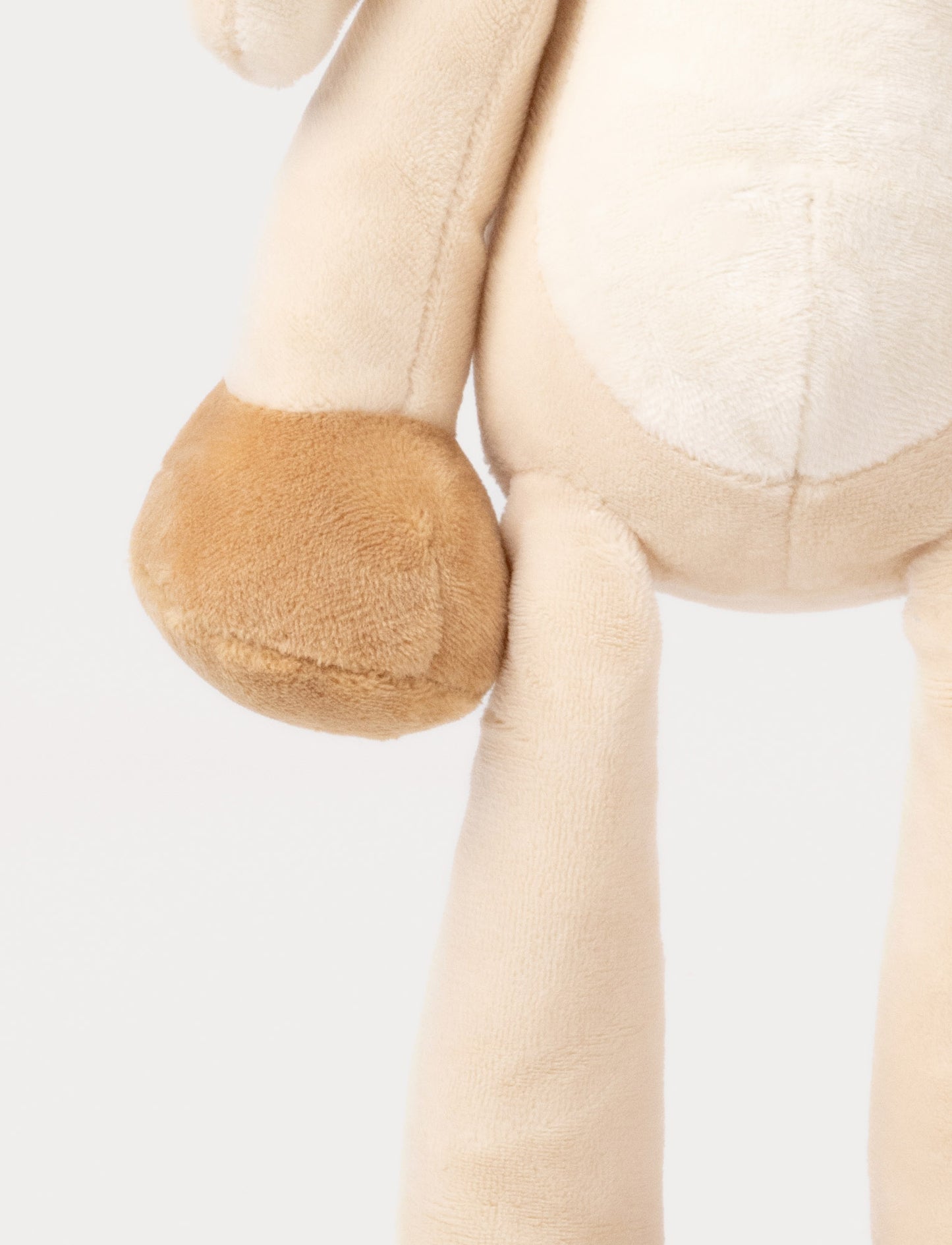 A plush beige bunny with long floppy ears, a white belly, and brown paws.