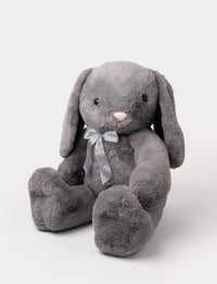 Soft grey plush bunny with long floppy ears, a pink nose, and a silver ribbon around its neck.