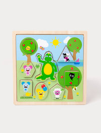 A wooden Bolibompa puzzle featuring the green dragon and colorful animal characters in a sunny landscape.