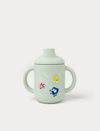 Green Babblarna silicone cup with handles, spill-proof lid, and colorful character design.