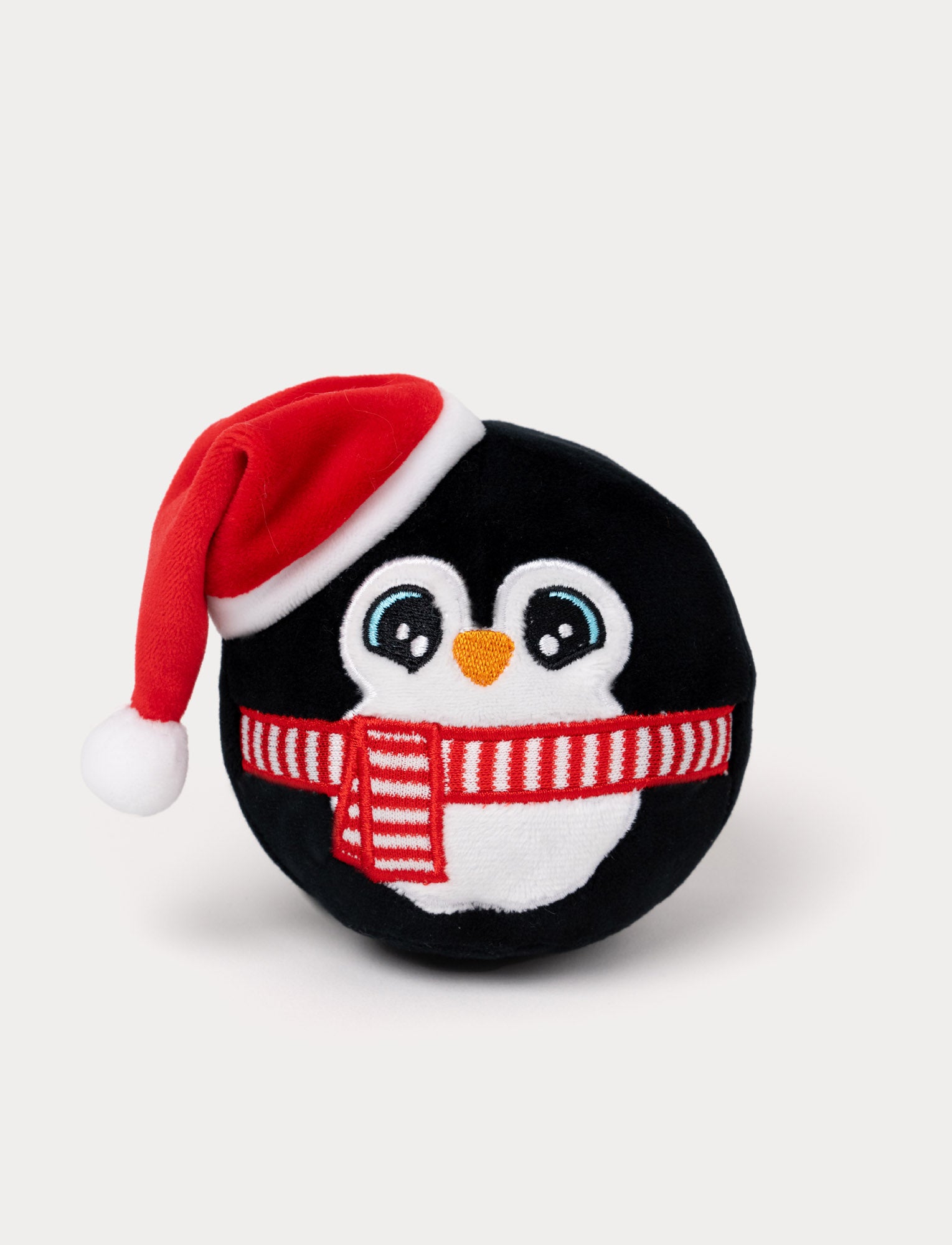  Image of Penguin plush toy wearing a Santa hat and scarf on a white background