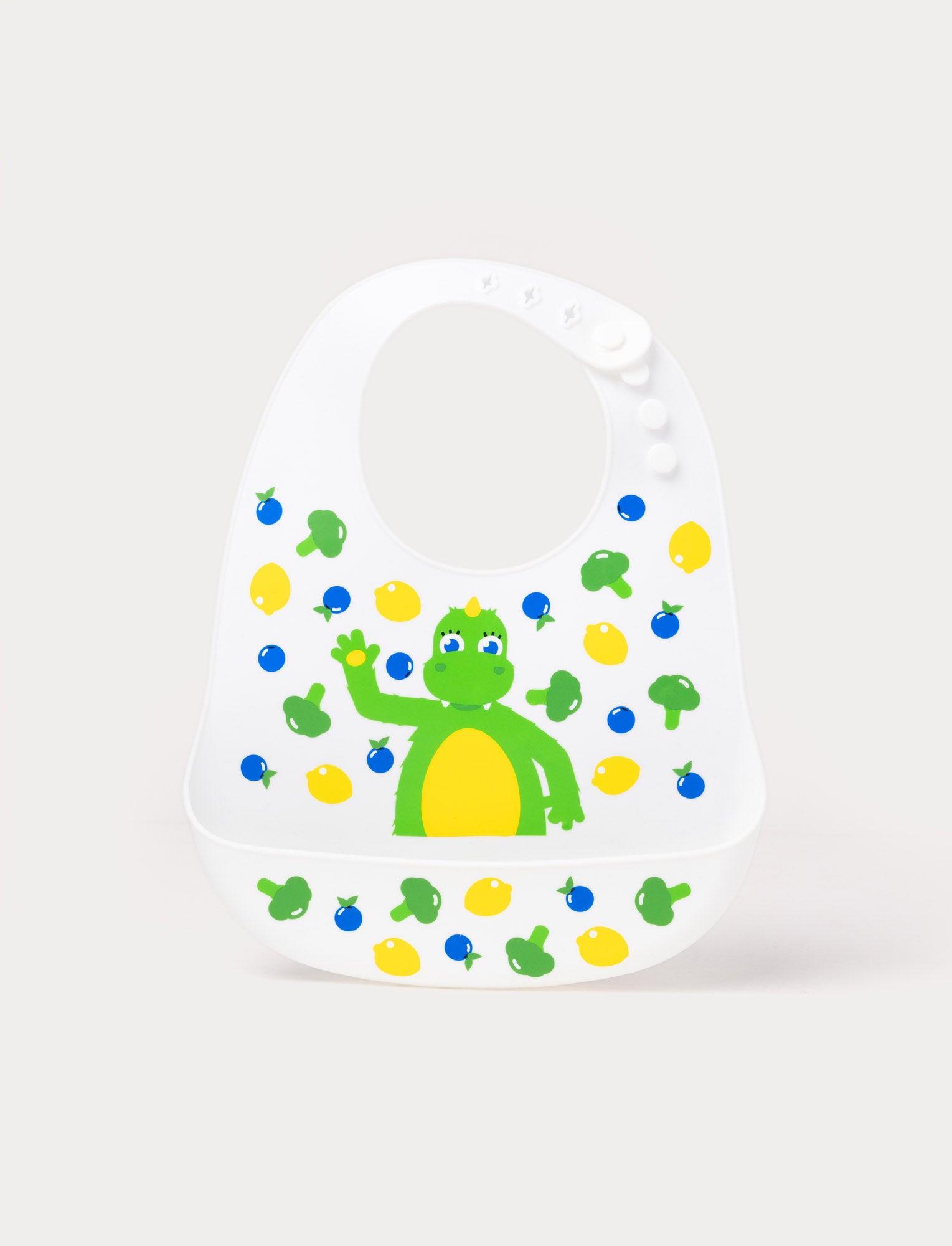  Image of Soft silicone bib in pastel colors with a cute Bolibompa design, featuring an adjustable closure and deep spill pocket.