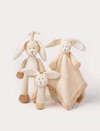 Set of three beige rabbit plush toys, including a rattle, comfort blanket, music box