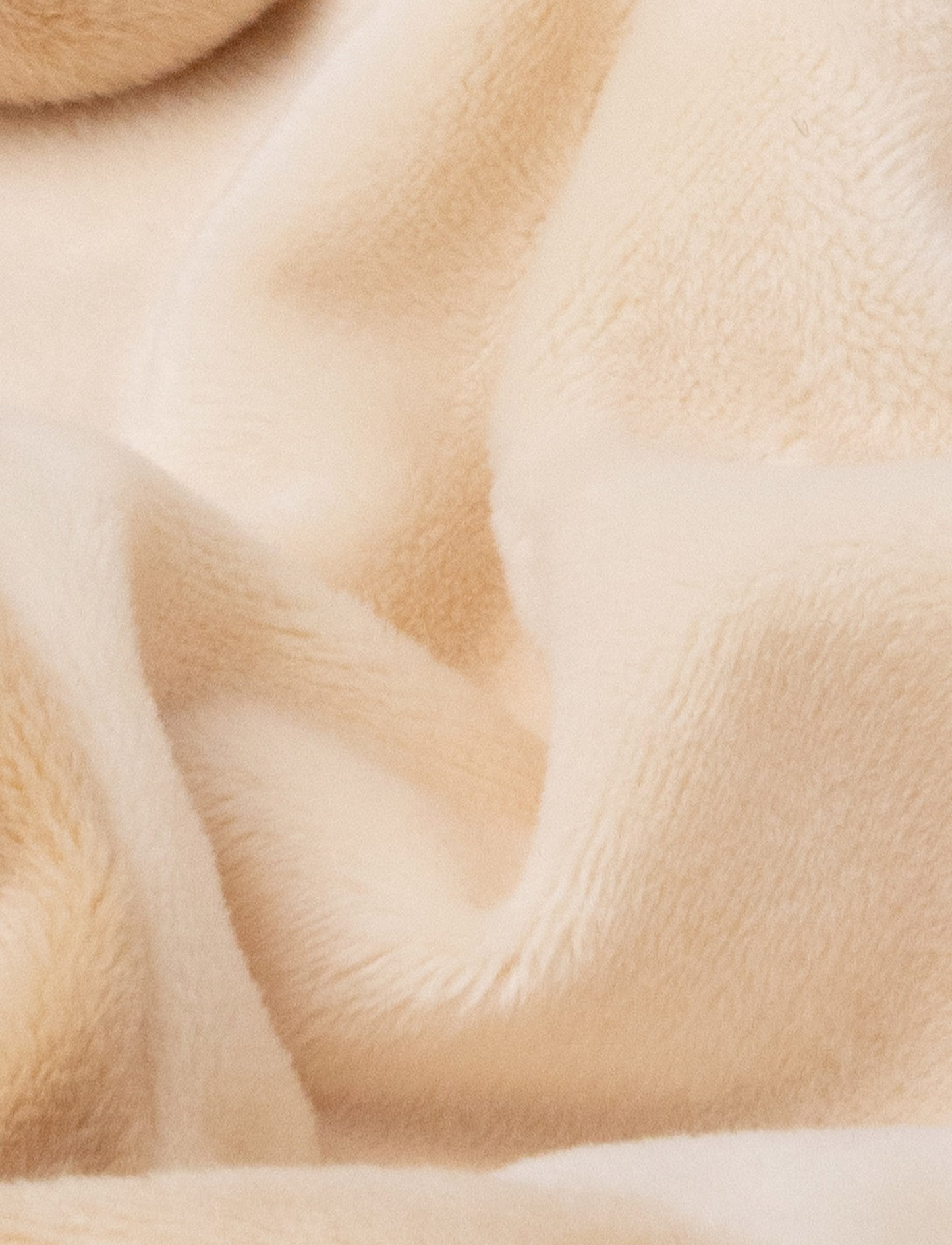 A beige-brown baby blanket with a soft plush bunny, white contrast details