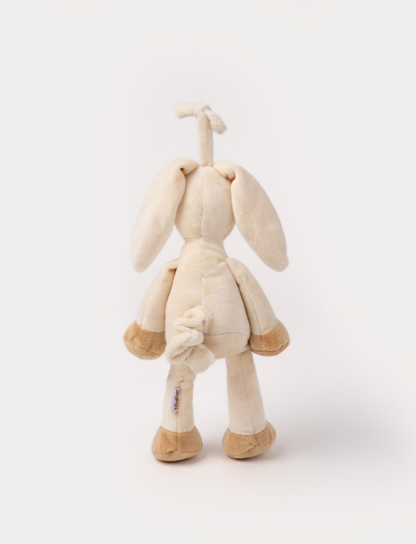 A plush beige bunny music box with floppy ears, a white belly, and a hanging loop.