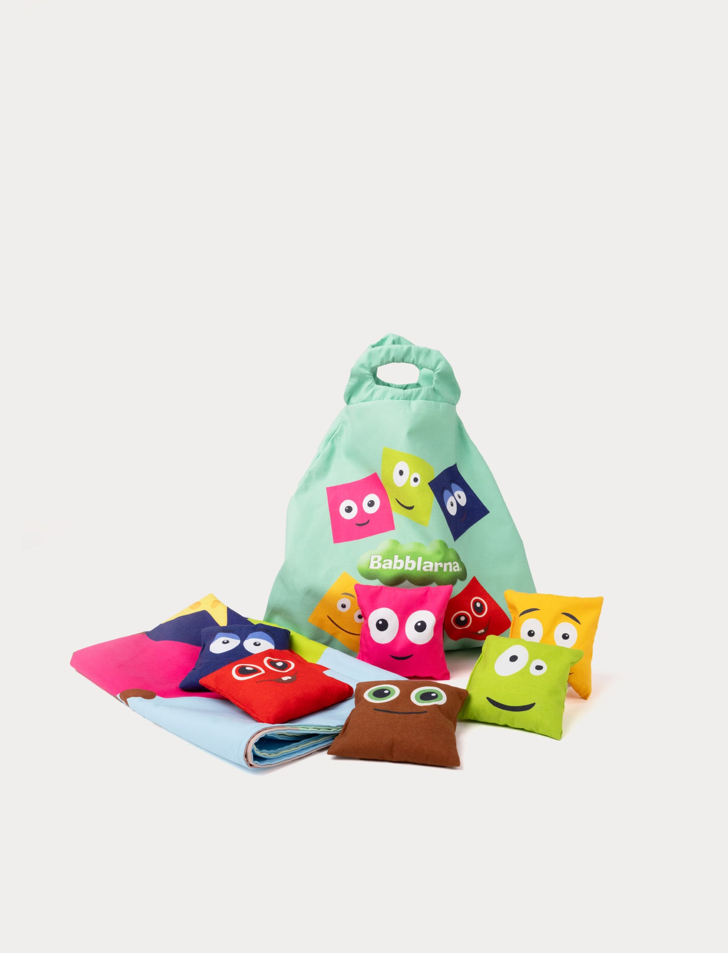 Babblarna bean bag game set with colorful fabric bean bags, play mat, and a green carrying bag featuring Babblarna characters.