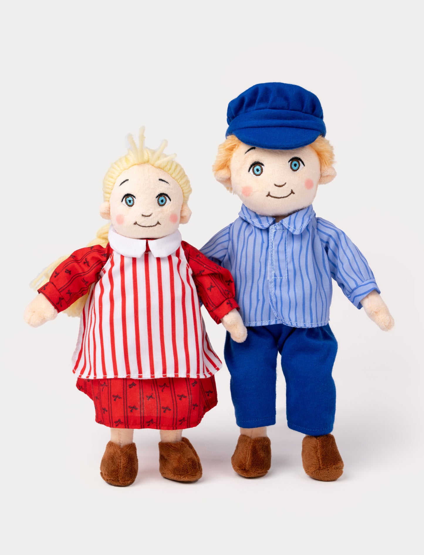 Two Emil of Lönneberga dolls. Ida in a red dress and white apron, Emil in a blue outfit with a cap