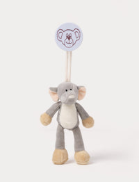 A plush elephant clip toy with large ears, a white belly, beige feet, and a round bear-illustrated clip.