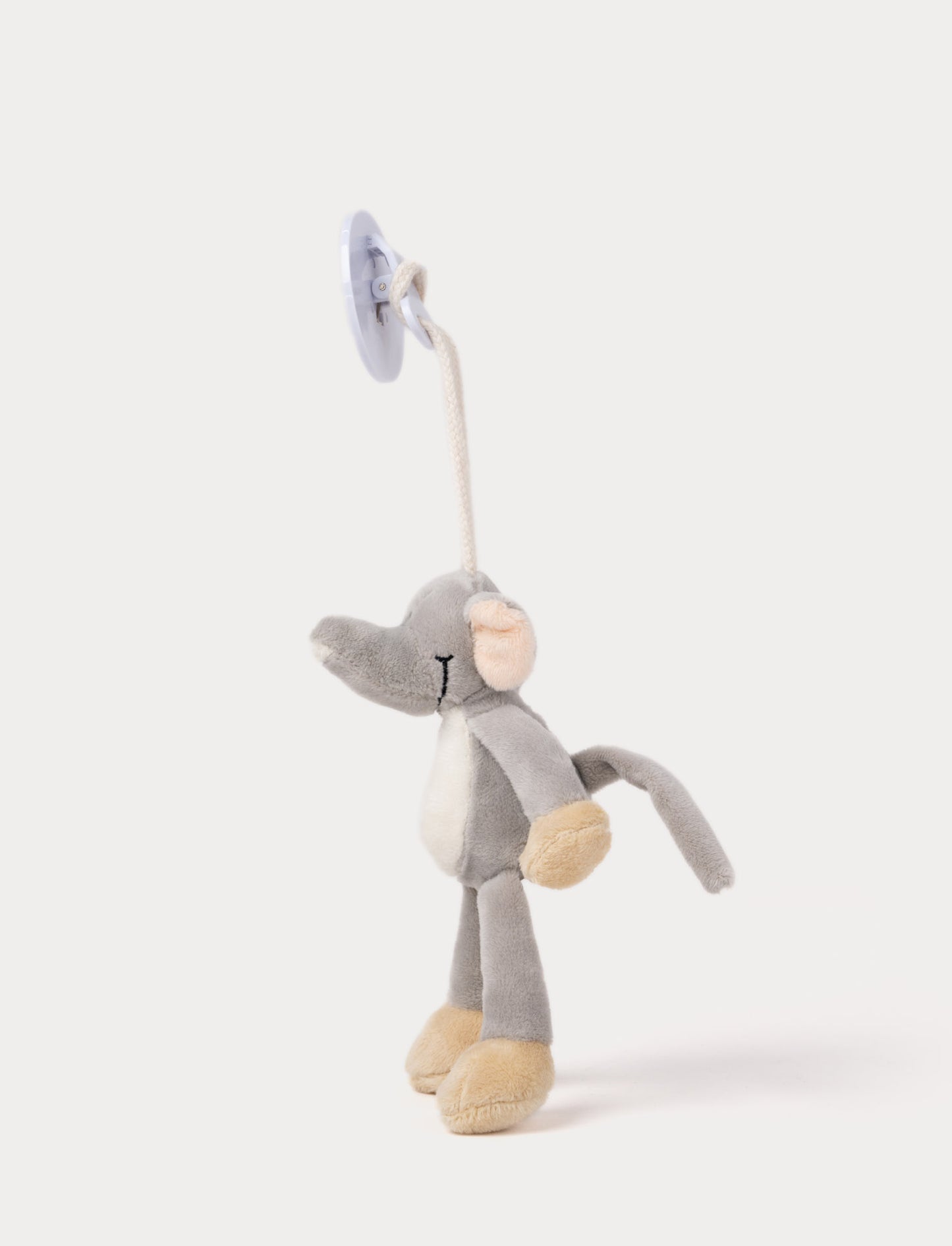 A plush elephant clip toy with large ears, a white belly, beige feet, and a round bear-illustrated clip.