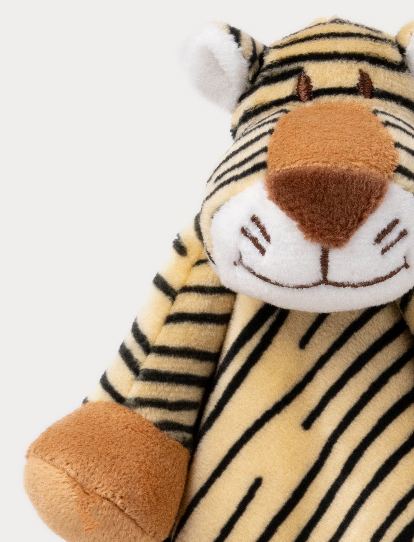 A soft tiger-shaped baby blanket with beige and brown details