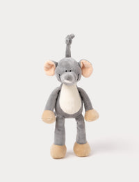 A plush elephant music box with large ears, a white belly, beige feet, and a fabric loop for hanging.