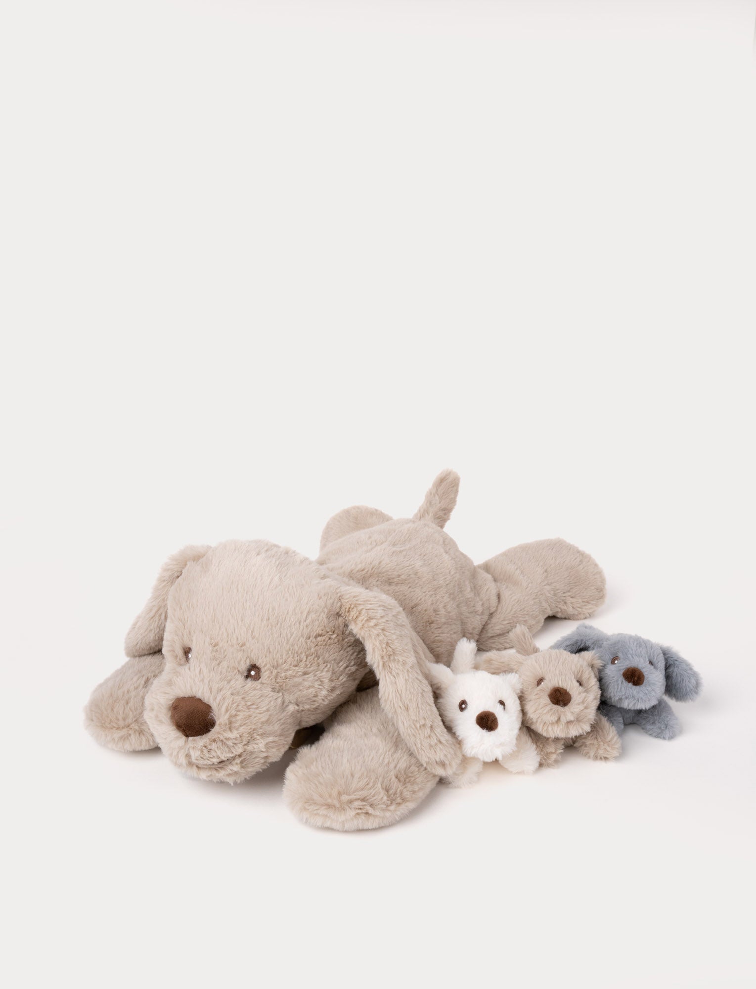  Image of Soft beige plush dog with three small puppy plush toys in white, blue, and beige, designed to fit inside the larger dog’s zippered opening