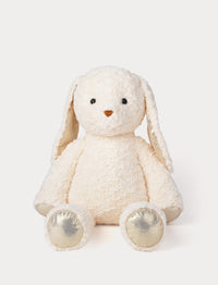 White plush bunny toy with gold shimmering details on a white background