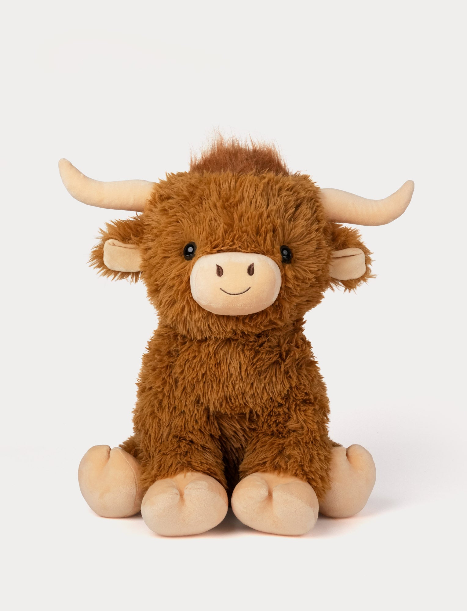 Image of Plush toy fluffy highland cow on a white background