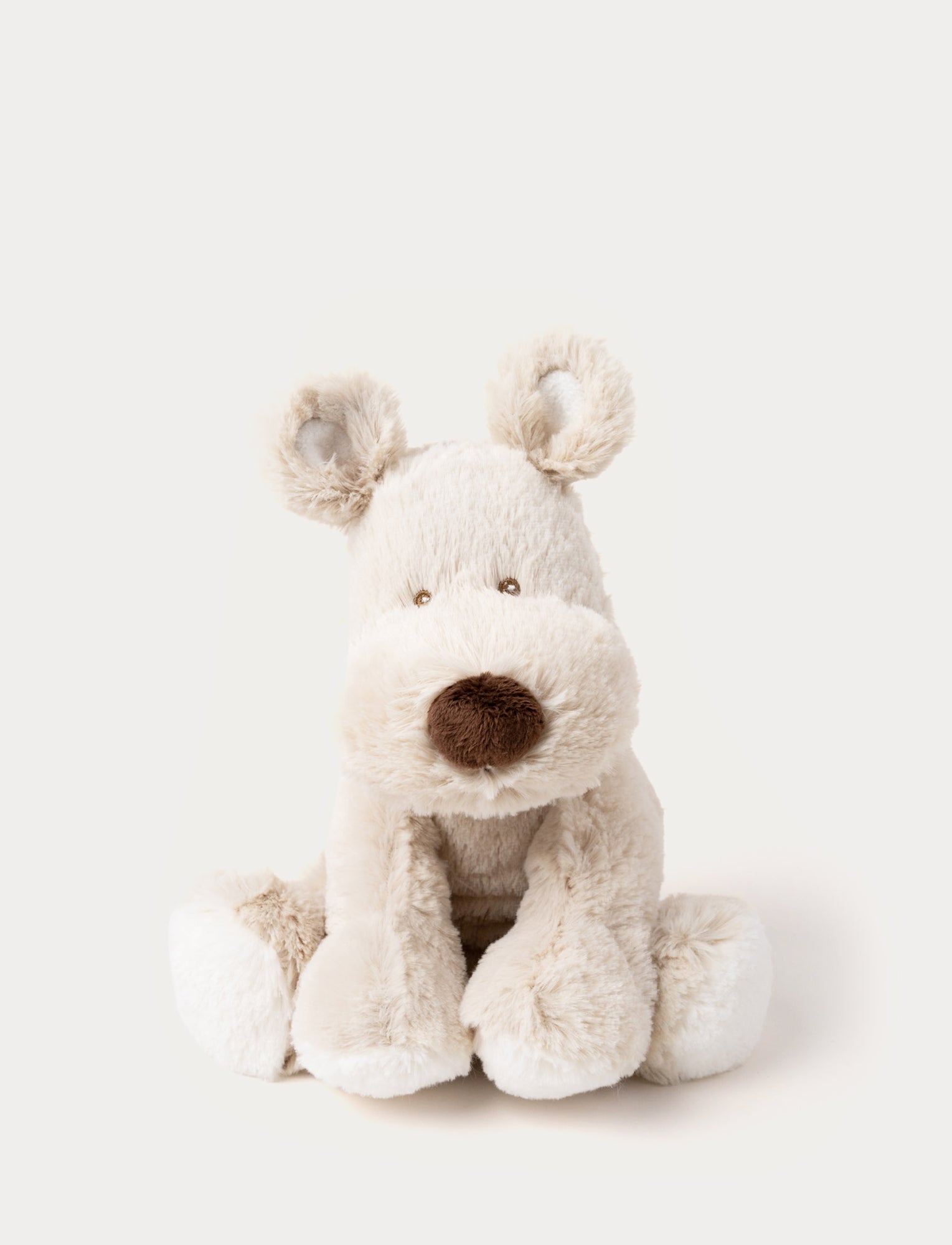  Image of A beige dog with stitched brown eyes, nose, and a white heart on its back.