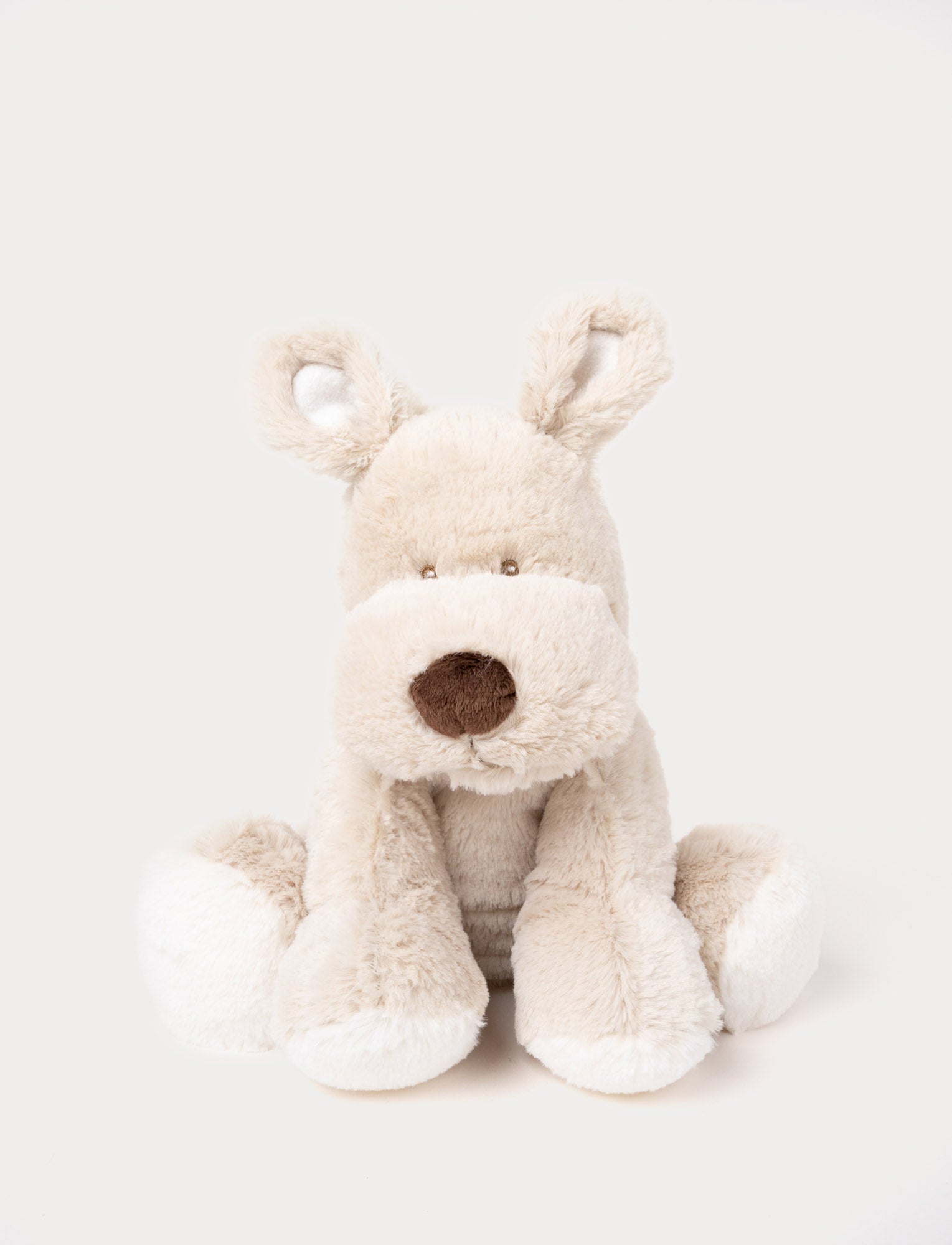  Image of Soft, light beige plush dog with floppy ears, a round brown nose, and white paws.
