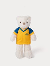 Stuffed teddy bear toy wearing a yellow and blue football shirt 
