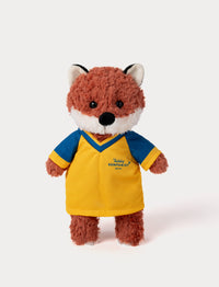Stuffed fox toy wearing a yellow and blue football shirt 