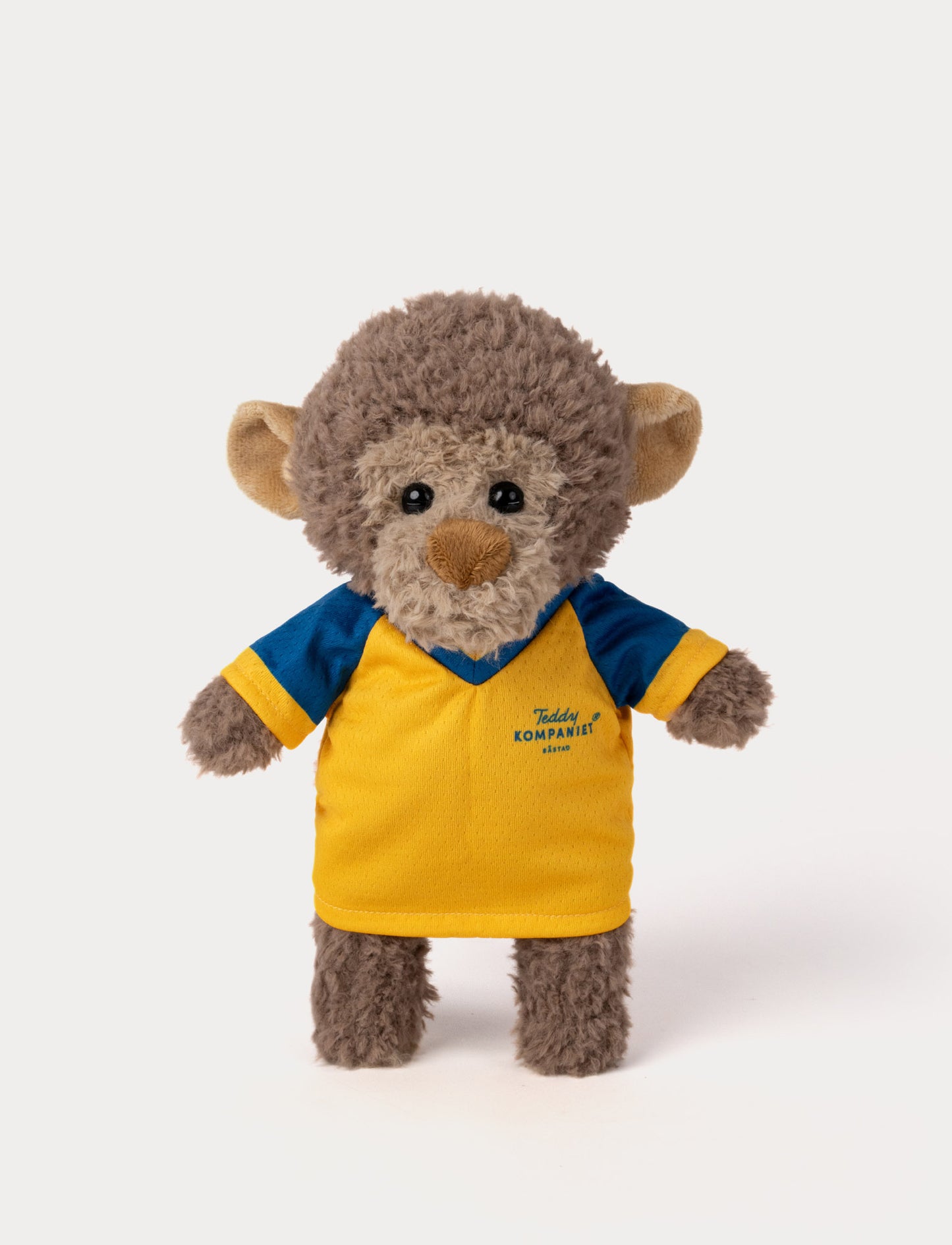 Stuffed monkey toy wearing a yellow and blue football shirt 