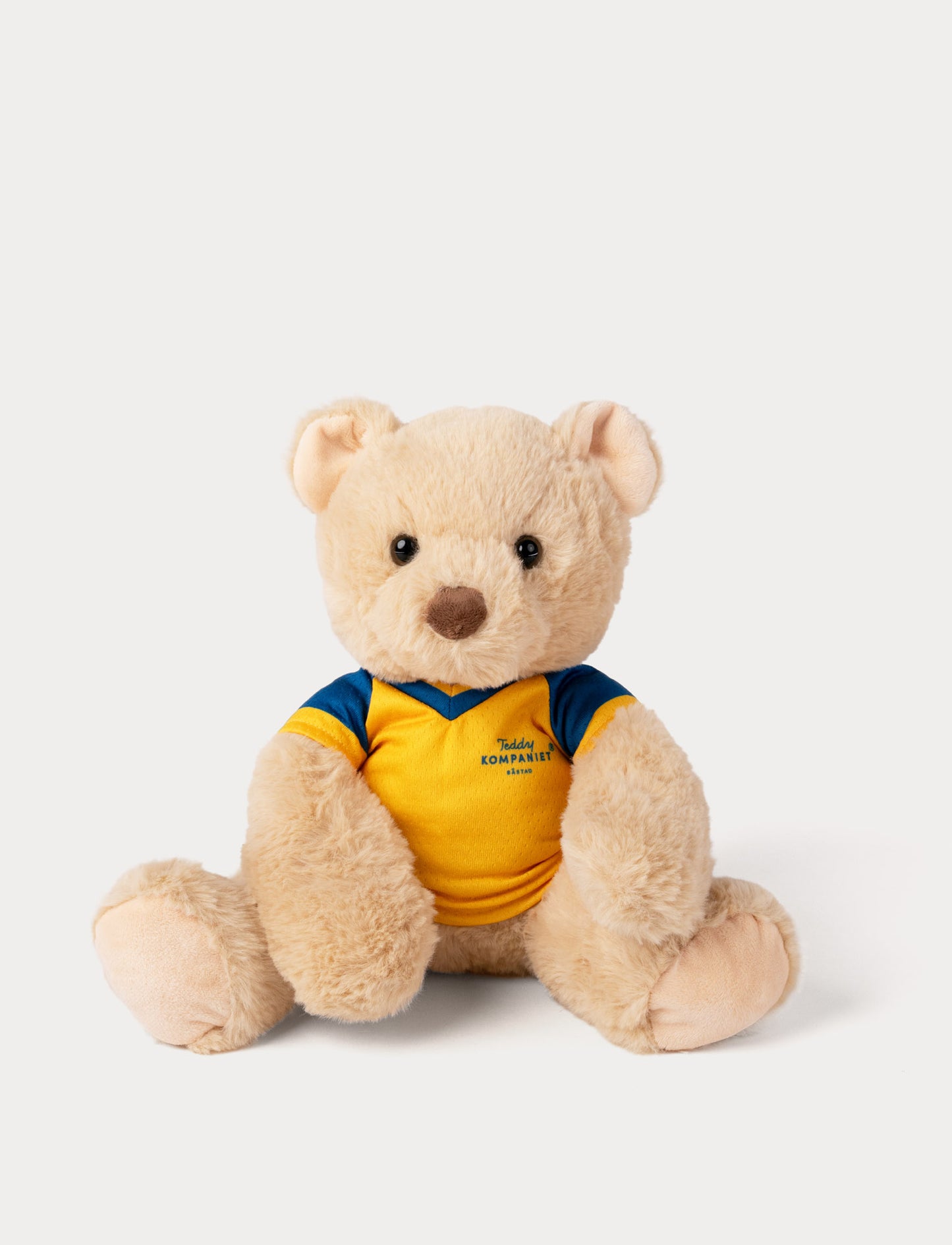 Stuffed teddy bear toy wearing a yellow and blue football shirt 