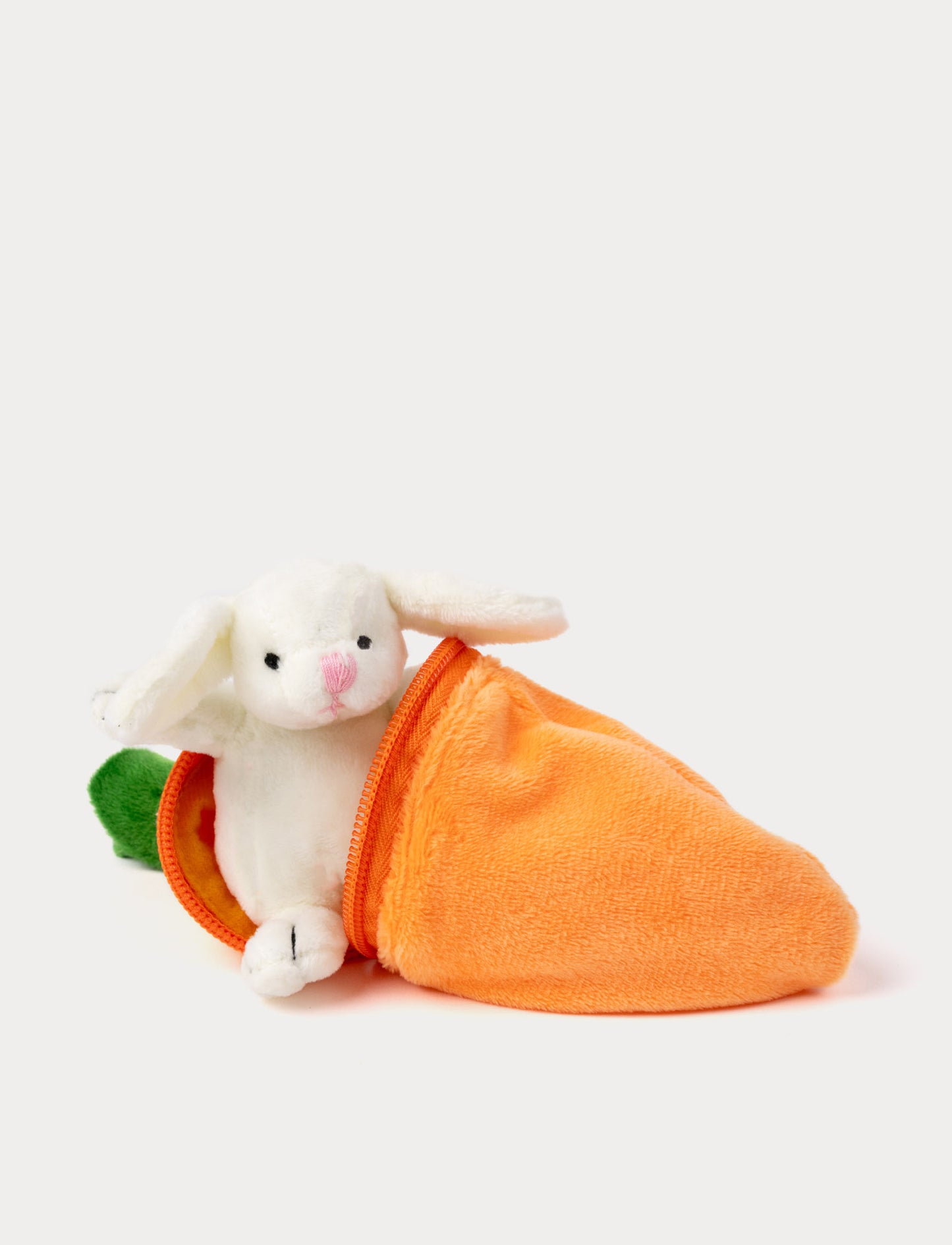 A small plush bunny peeks out from a soft, zippered carrot-shaped pouch.