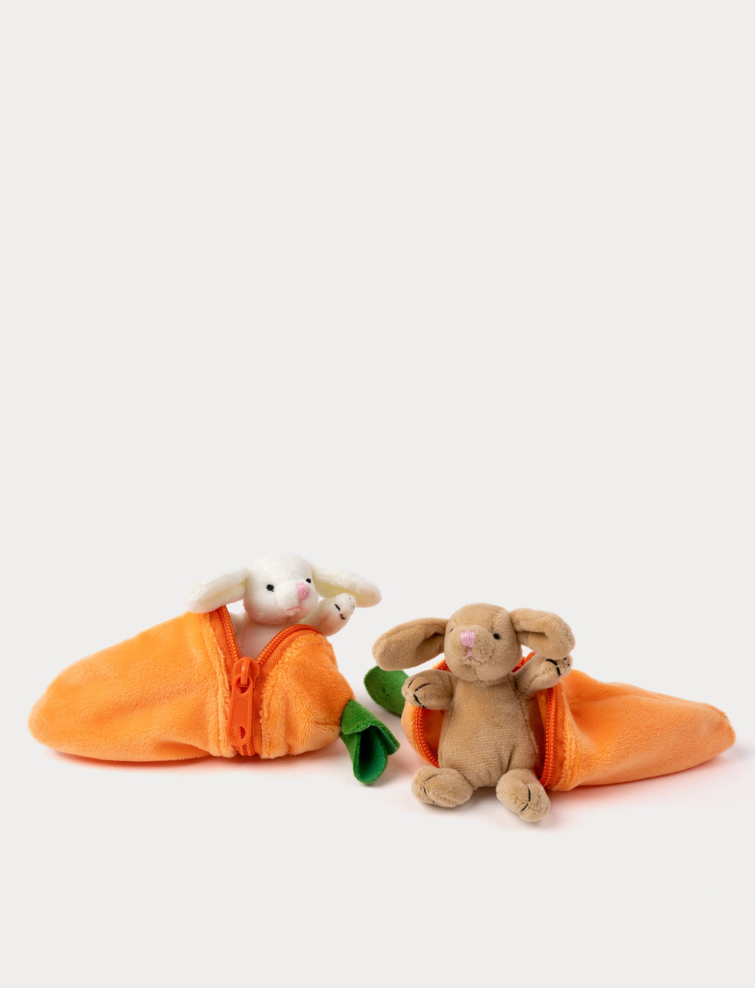  Image of Two small plush bunnies peeks out from a soft, zippered carrot-shaped pouch.