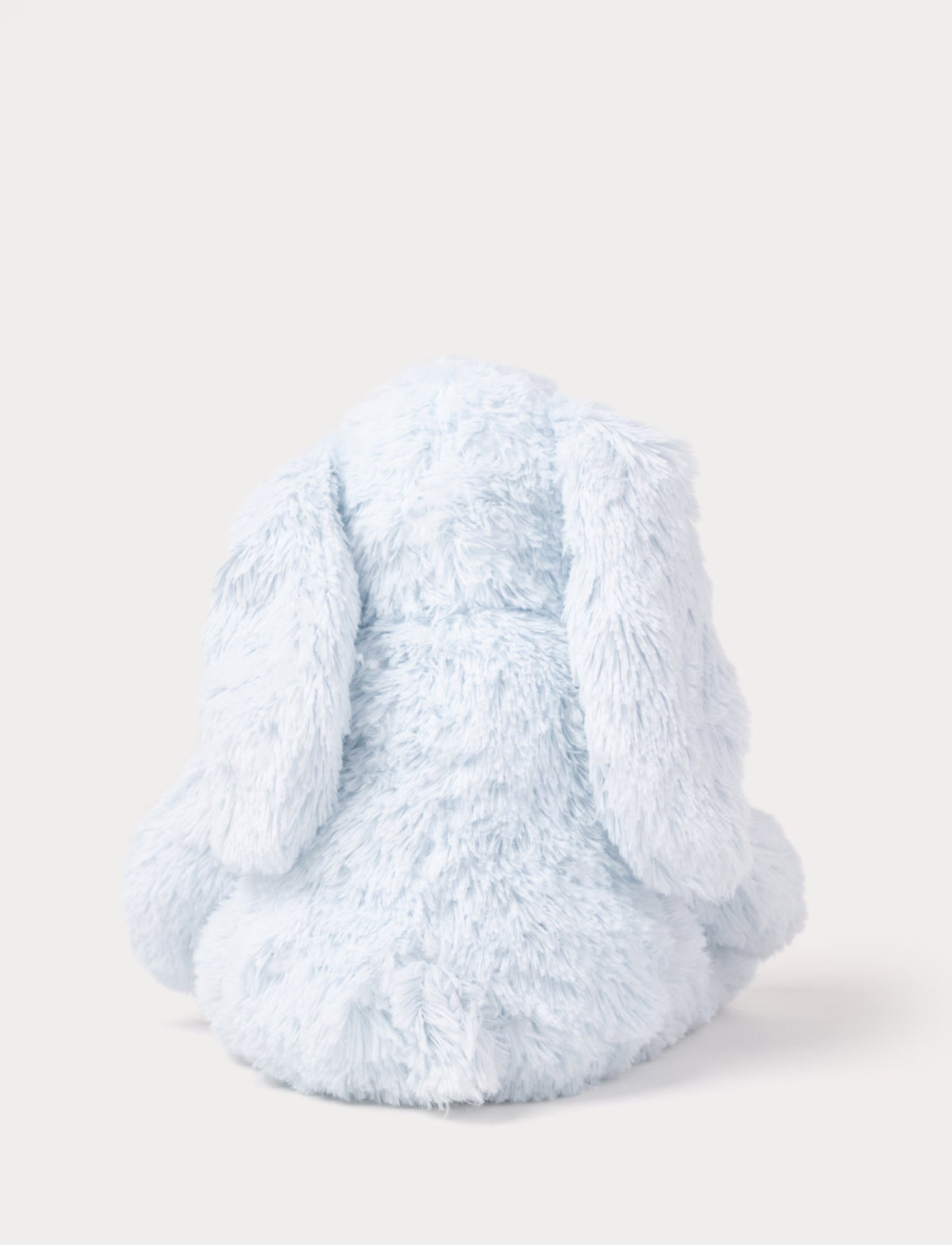 A soft blue plush bunny with floppy ears, a beige nose, and golden-stitched eyes.