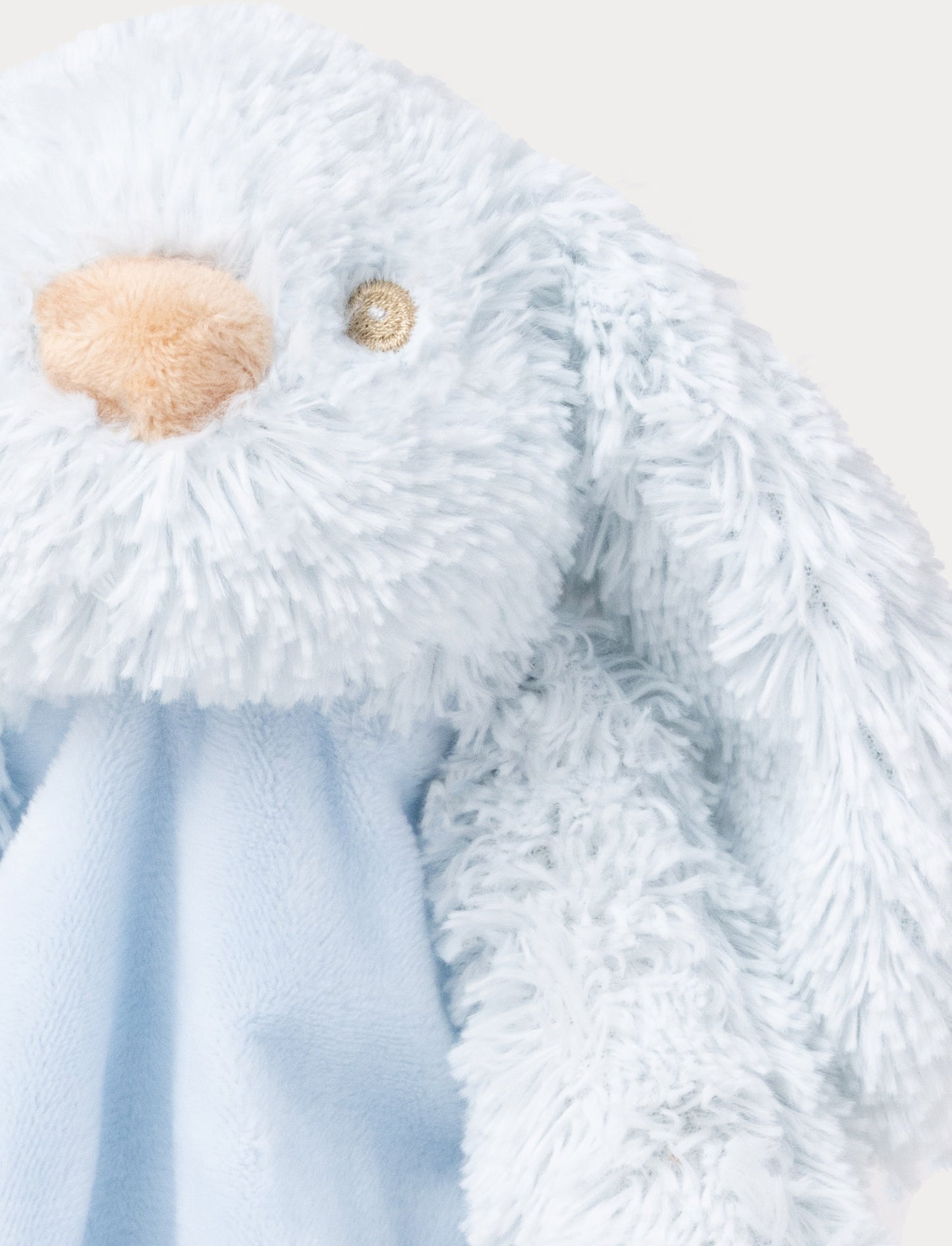 Soft plush bunny blanket with a light blue fabric body, floppy furry ears, and fluffy paws.