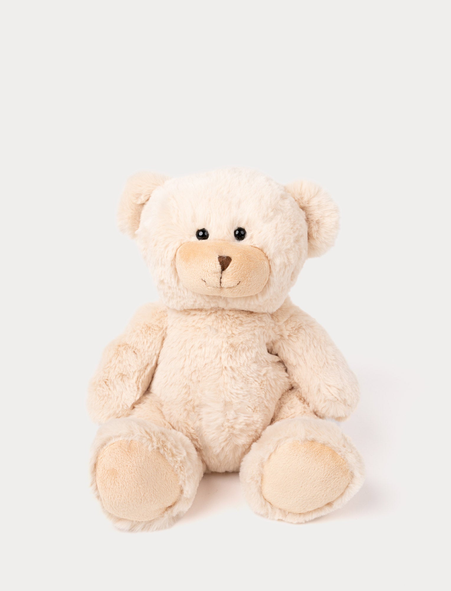  Image of Soft, light beige teddy bear with black eyes and a stitched brown nose