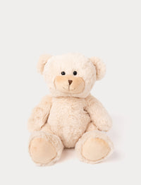 Soft, light beige teddy bear with black eyes and a stitched brown nose