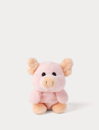 Small pig plush toy on pink