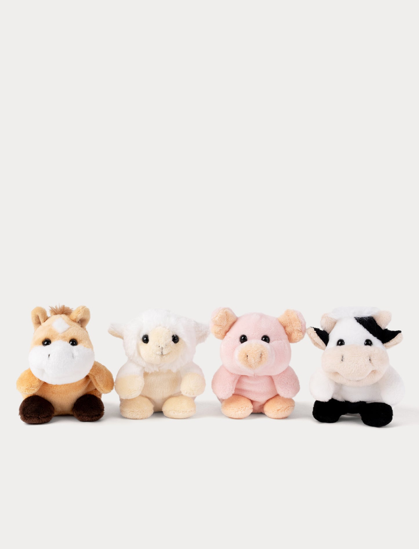 Four small plush toys shaped like a horse, sheep, pig, and cow on a white background