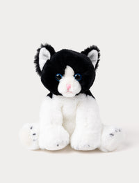Soft black and white kitten plush with blue eyes, a pink nose, and white paws.