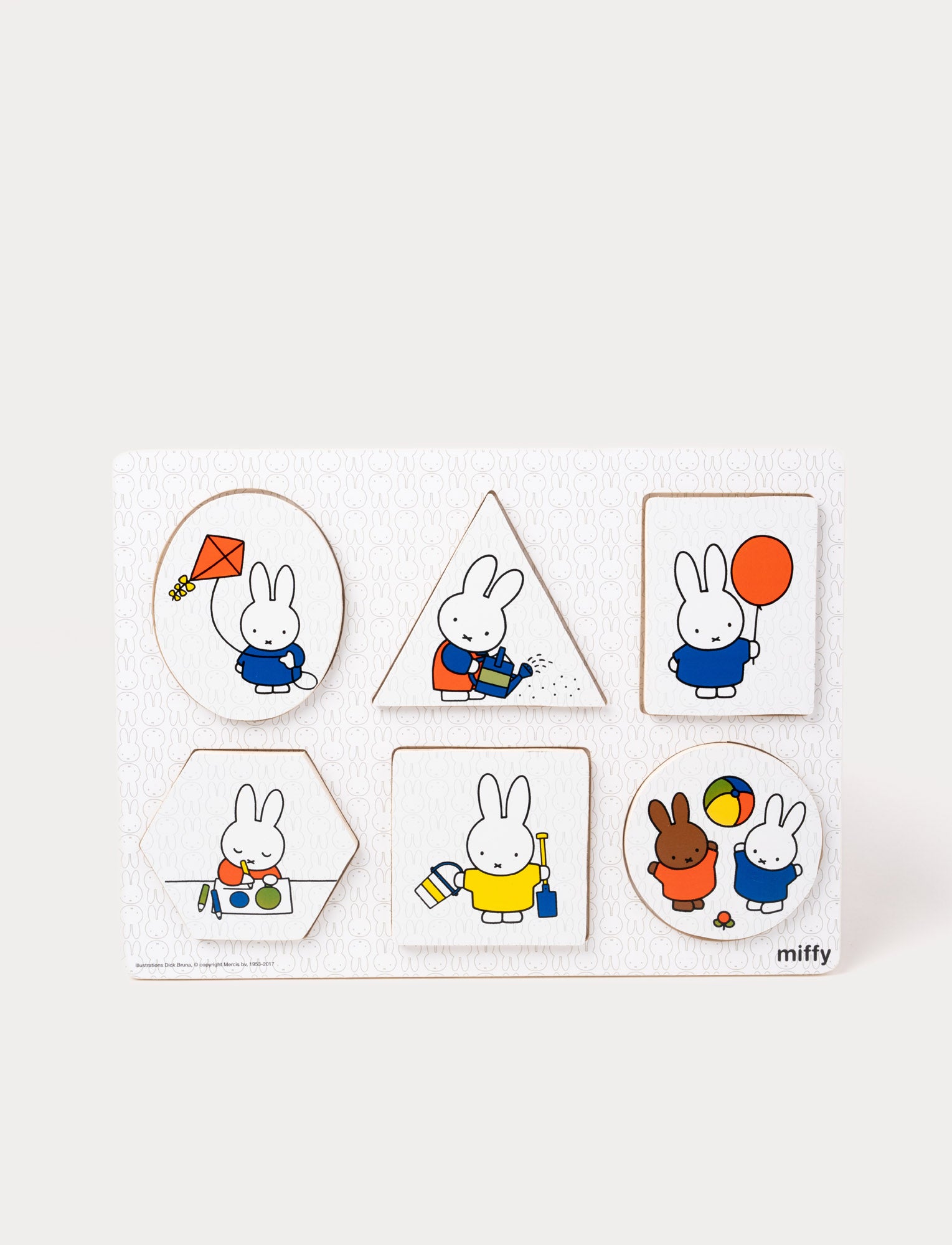  Image of Colorful Miffy shape puzzle with various pieces and illustrations that fits into matching shapes on a wooden board.