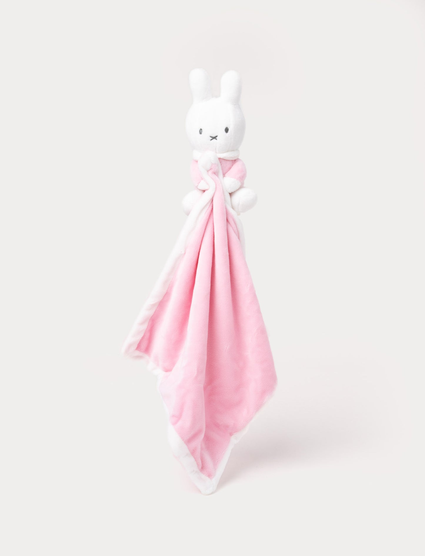 Soft pink baby blanket with a Miffy bunny on top, featuring a simple and cozy design.
