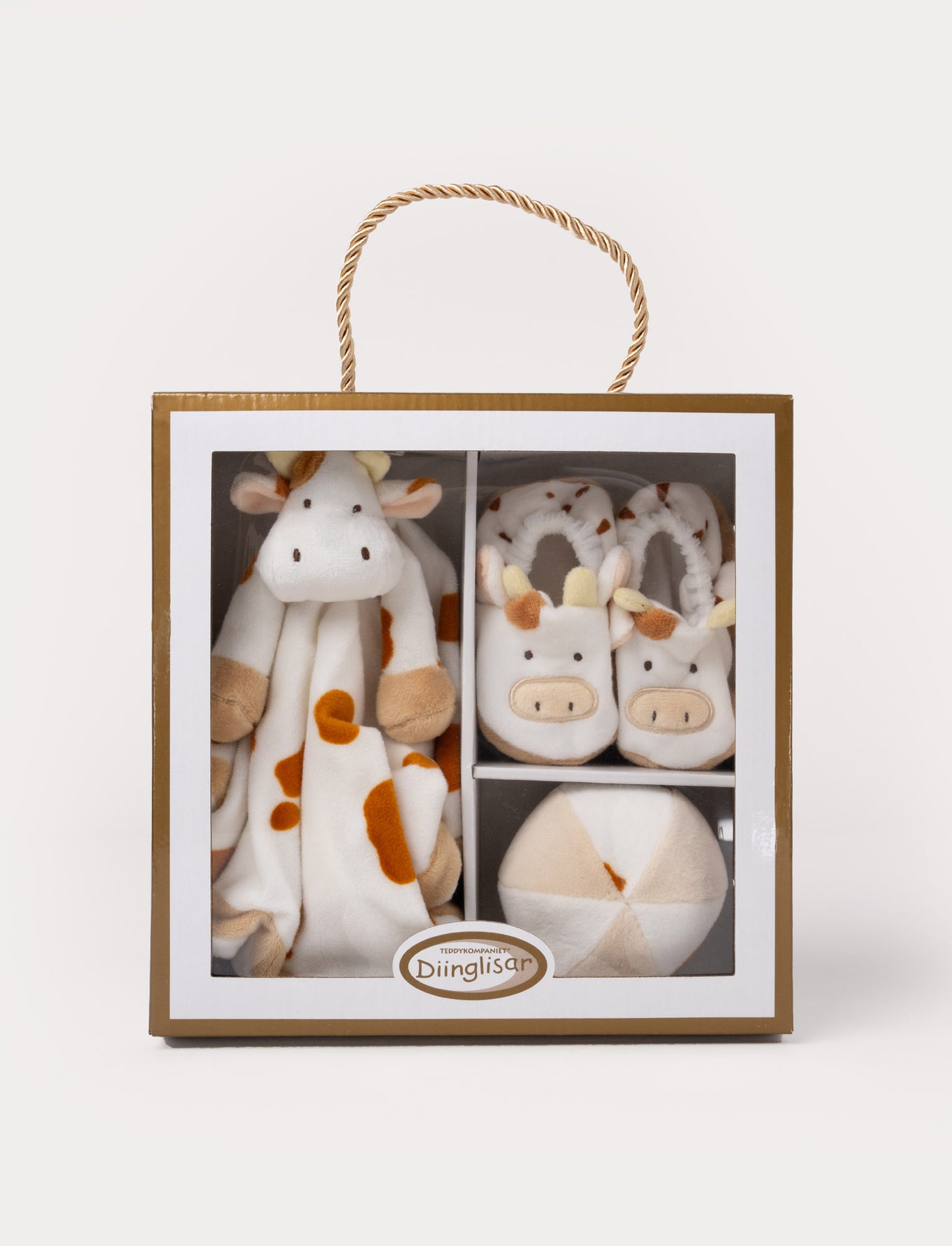 A Diinglisar gift box set featuring a plush cow comforter, matching slippers, and a soft toy ball.