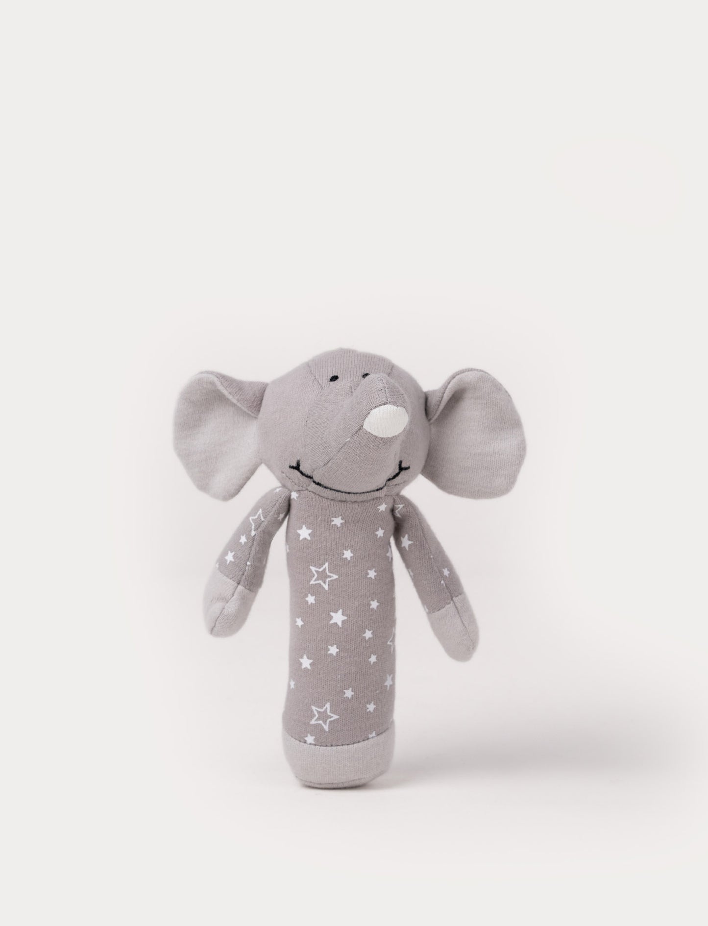 Grey elephant rattle toy with a soft fabric body decorated with white stars.