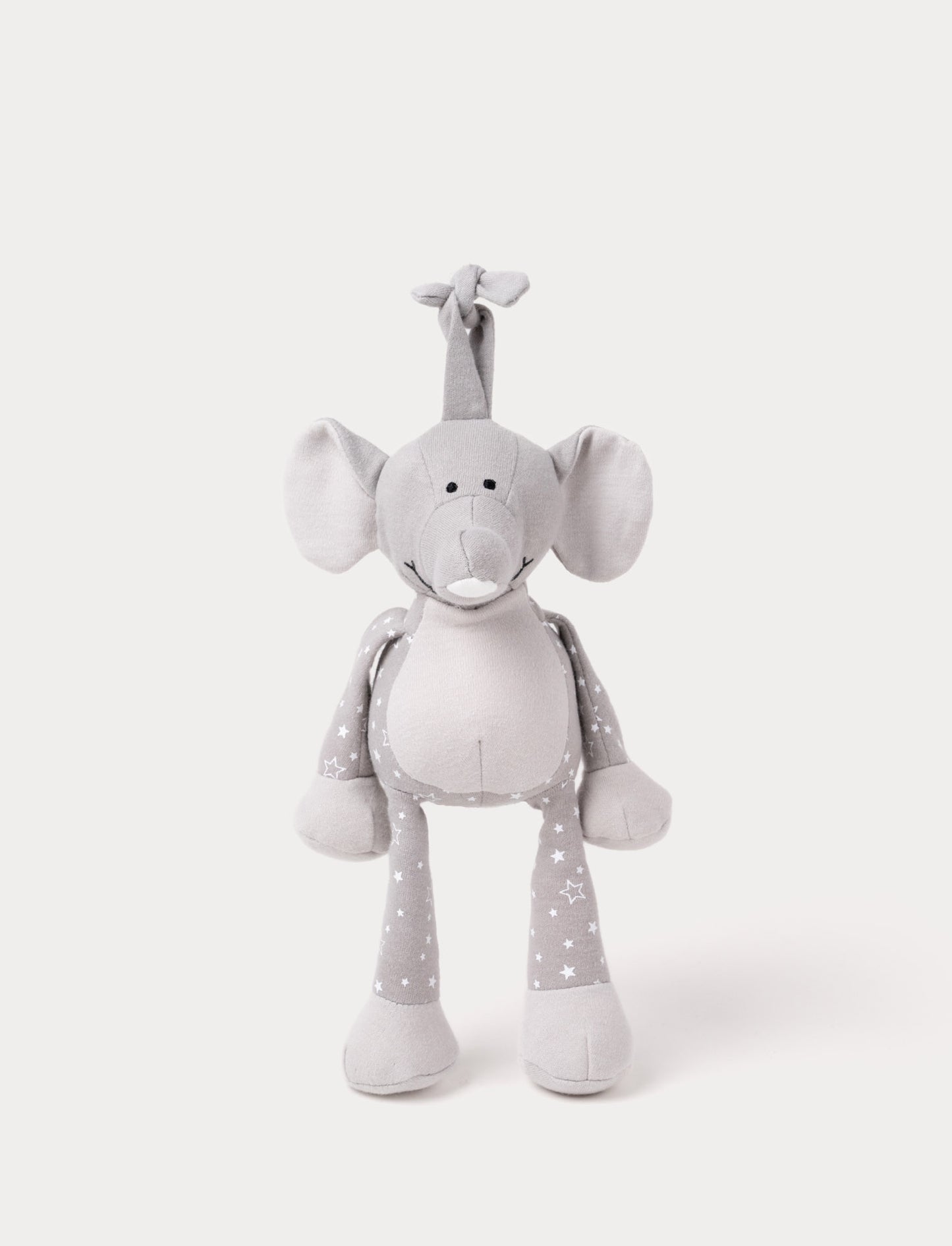A grey plush elephant music box with star-patterned limbs, large ears, and a fabric loop for hanging