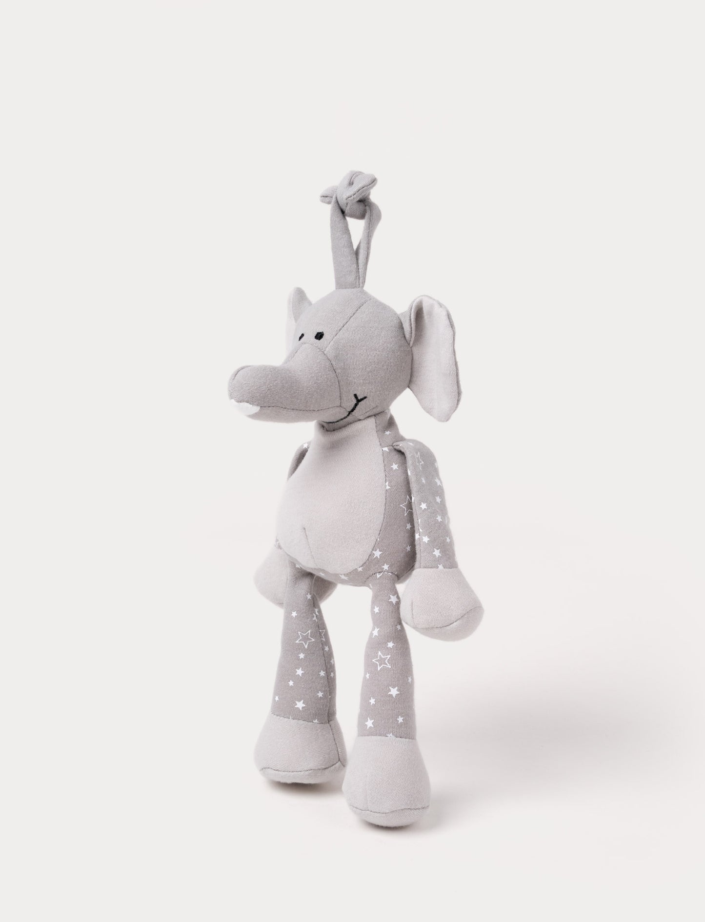 A grey plush elephant music box with star-patterned limbs, large ears, and a fabric loop for hanging