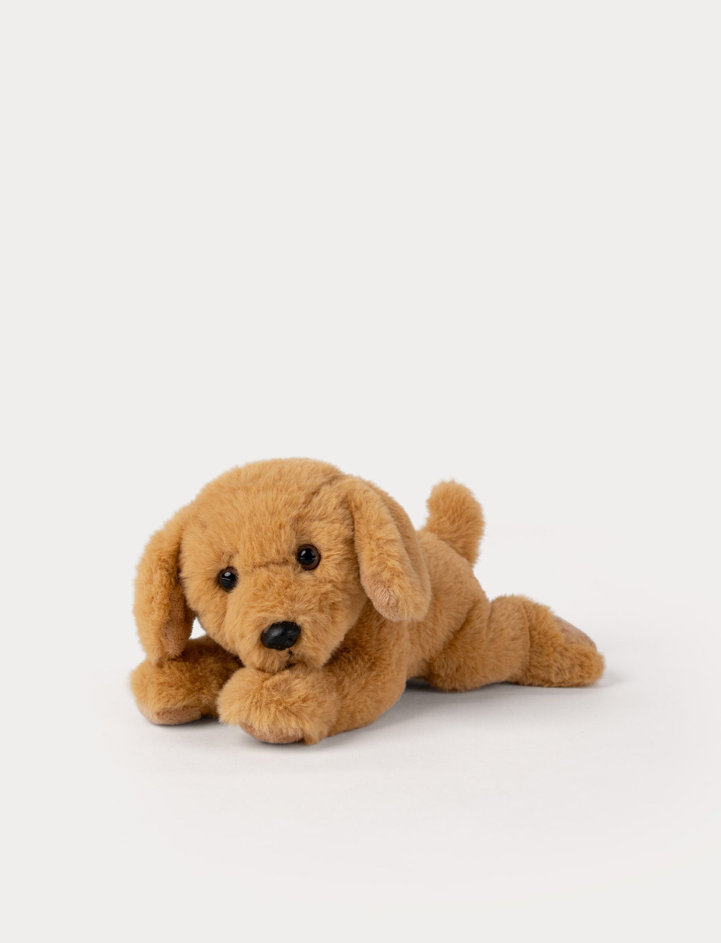 Brown plush dog toy on a white background
