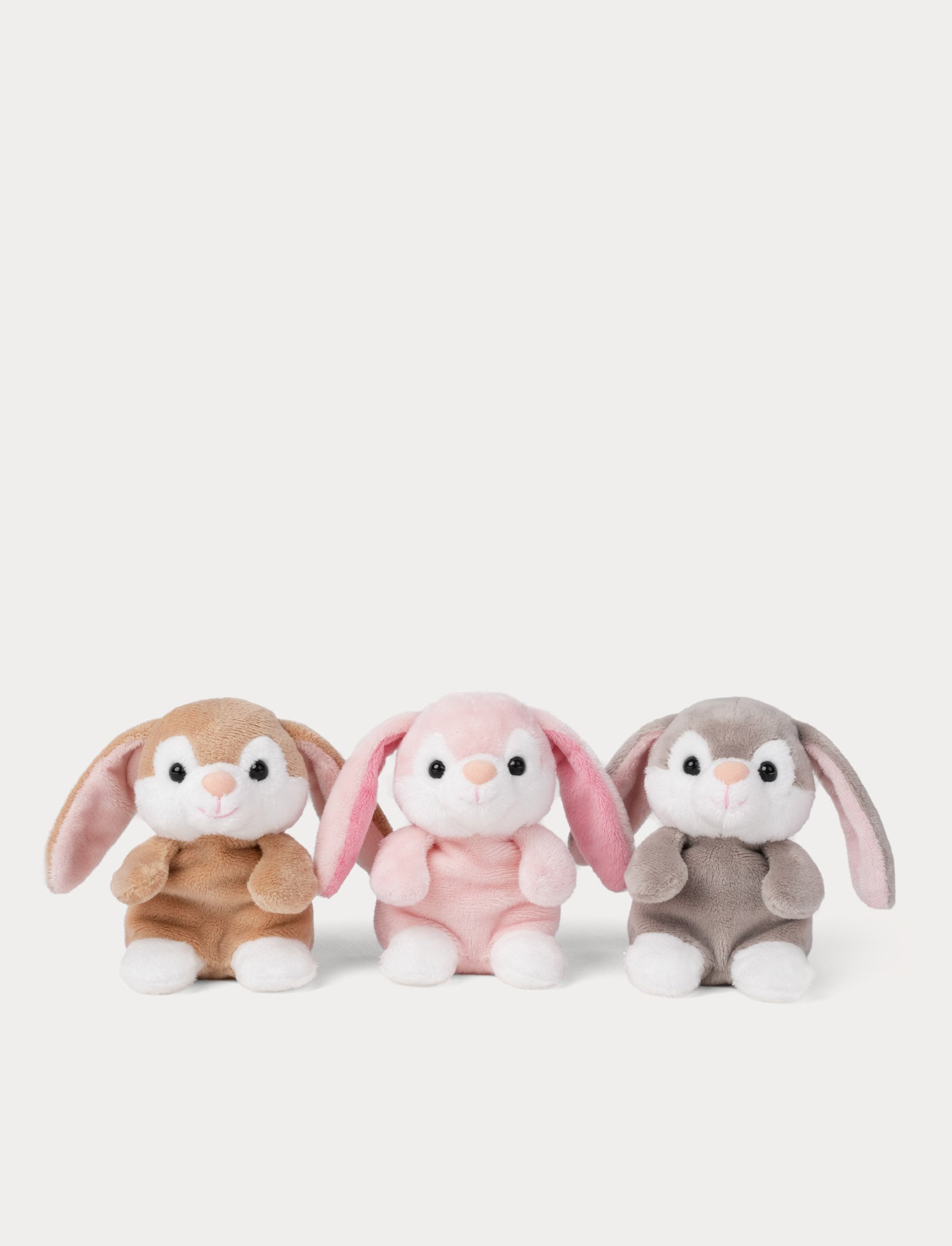  Image of Three plush toys resembling bunnies in pink, grey and brown