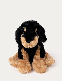Soft black and tan plush dog with floppy ears, black eyes, and a curly fur texture.