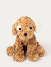 Soft, curly light brown plush dog with black eyes, a stitched black nose, and one white floppy ear.